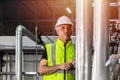 Factory engineer male worker checking high pressure pipe guage in factory boiler room Royalty Free Stock Photo