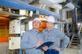 factory engineers operating hydraulic tube bender Royalty Free Stock Photo