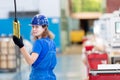 Factory female worker operating workshop gantry crane