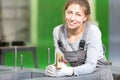 Factory female worker during power transformer magnetic core assembling