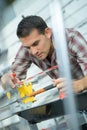 Factory man worker checking metal plank straightness at workshop Royalty Free Stock Photo