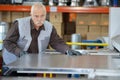 Factory man worker holding metal sheet in workshop Royalty Free Stock Photo