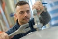 Factory man worker measuring detail with vernier caliper at workshop Royalty Free Stock Photo