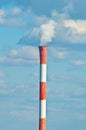 Factory pipe smoking with a white smoke over the blue sky