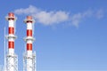 Factory plant smoke stack over blue sky background. Thermal condensing power plant. Energy generation and air environment pollutio Royalty Free Stock Photo