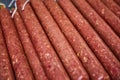 Factory for the production of meat products, boiled sausages. Traditional spicy sausage, ready to dry, lies on the table.