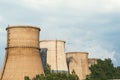 The factory releases smoke into the sky from pipes polluting the atmosphere