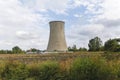 Agriculture field and a cooling chimney from a ruined factory Royalty Free Stock Photo