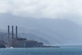 Factory at the sea, in front of mountain