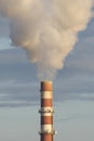 Factory smokestack against the blue sky. White smoke close up Royalty Free Stock Photo