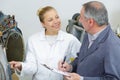 Factory supervisor giving instructions to female apprentice