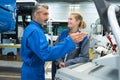 Factory supervisor giving instructions to female worker