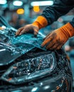 Worker inspecting a shiny black car interior during automotive manufacturing process Royalty Free Stock Photo