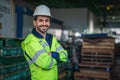 Factory warehouse foreman and supervisor in front of wearhouse pallets storage