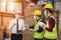 Factory warehouse manager speak with Asian worker working together with safety and face mask Royalty Free Stock Photo