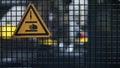 Factory warning icon sign on grid attention to dangerous machine working Royalty Free Stock Photo