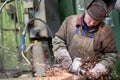 Factory welder worker grinding steel sheet