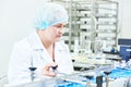 Factory woman worker operating production line