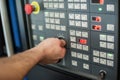 Factory worker adjusts the control panel of industry machine Royalty Free Stock Photo