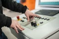 Factory worker adjusts the control panel of industry machine Royalty Free Stock Photo