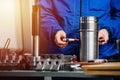 Factory worker assembling cylindrical steel bearing. Cropped, no face. Royalty Free Stock Photo