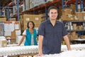 Factory Worker Checking Goods On Production Line