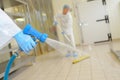 Factory worker cleaning floor