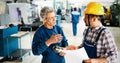 Factory worker discussing data with supervisor in metal factory Royalty Free Stock Photo