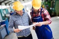 Factory worker discussing data with supervisor in metal factory Royalty Free Stock Photo