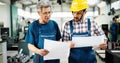 Factory worker discussing data with supervisor in metal factory Royalty Free Stock Photo
