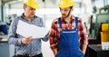 Factory worker discussing data with supervisor in metal factory Royalty Free Stock Photo