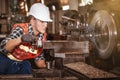 Worker doing work with  metal lathe machine carving & a piece of metal scrap and debris Royalty Free Stock Photo