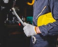 The factory worker holding a hard hat and a wrench Royalty Free Stock Photo