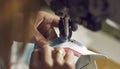 Factory worker making details for new leather shoes on industrial sewing machine Royalty Free Stock Photo