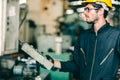 Factory worker man intend to operate the machine, high skill labor work industry with safety clothes Royalty Free Stock Photo