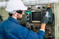 Factory worker man operate the machine, high skill labor work industry with safety clothes Royalty Free Stock Photo