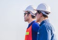 Factory worker man team in hard hat and looking at sky with joy, Happiness and teamwork concept