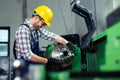 Factory worker measure detail with digital caliper micrometer during finishing metal working on lathe machine Royalty Free Stock Photo