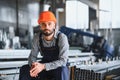 Factory worker measures the metal profile