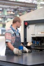 Factory worker operating coordinate punching machine Royalty Free Stock Photo