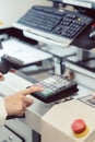 Factory worker pressing the OK button on a machine
