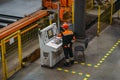 Factory worker programming CNC machine in metalworking workshop