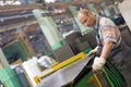 Factory worker removing metal burrs from steel sheet Royalty Free Stock Photo