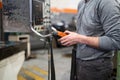 Factory worker. Technician controlling a heavy crane in factory, close up at his hands holding a crane controller.