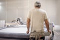 Technician works on CNC digital cutter machine for cutting textile Royalty Free Stock Photo