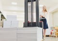 Factory Worker Using Powered Fork Lift To Load Goods. young woman Royalty Free Stock Photo