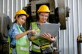 Factory worker women discuss together with laptop in workplace area. Concept of good teamwork and management system help and Royalty Free Stock Photo