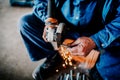 factory worker working and cutting steel iron with angle grinder