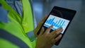 Factory workers analizing graphs checking data on tablet screen hands closeup