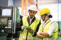 Factory workers check stock in tablet